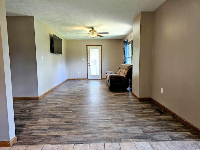 102 Hazelnut Ave, Camden, TN 38320 - unfurnished room featuring ceiling fan, wood finished floors, baseboards, and a textured ceiling