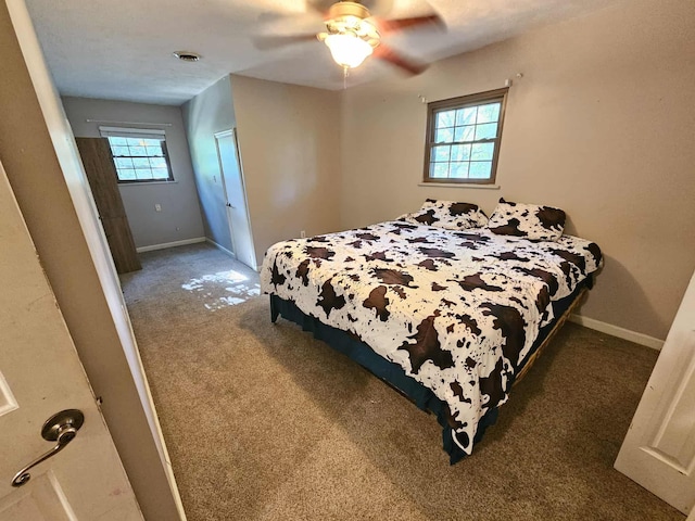 102 Hazelnut Ave, Camden, TN 38320 - carpeted bedroom with baseboards and a ceiling fan