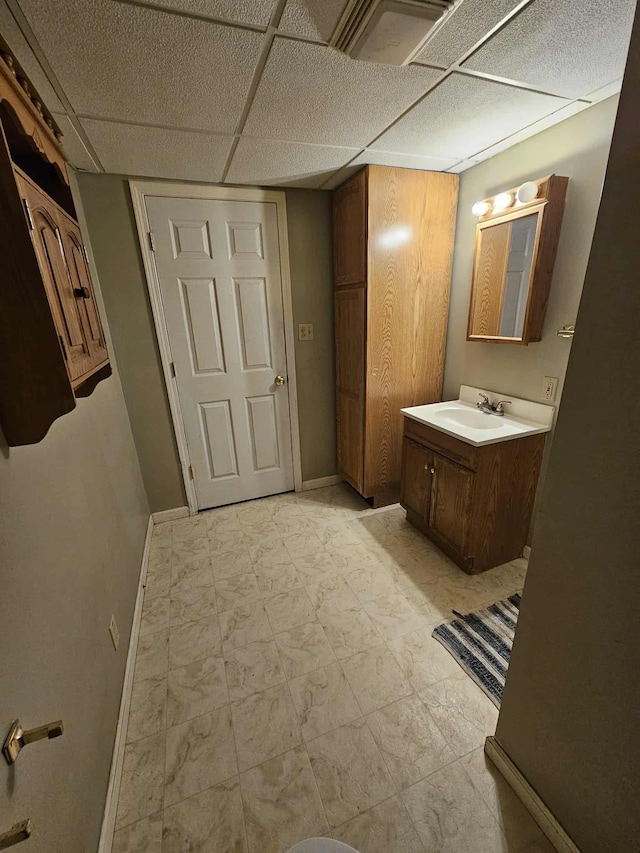 102 Hazelnut Ave, Camden, TN 38320 - bathroom featuring baseboards, vanity, marble finish floors, and a paneled ceiling