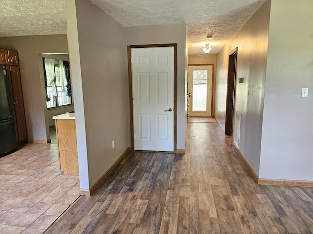 102 Hazelnut Ave, Camden, TN 38320 - hallway featuring a textured ceiling, baseboards, and wood finished floors