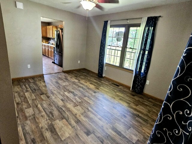 102 Hazelnut Ave, Camden, TN 38320 - unfurnished room with a ceiling fan, wood finished floors, and baseboards