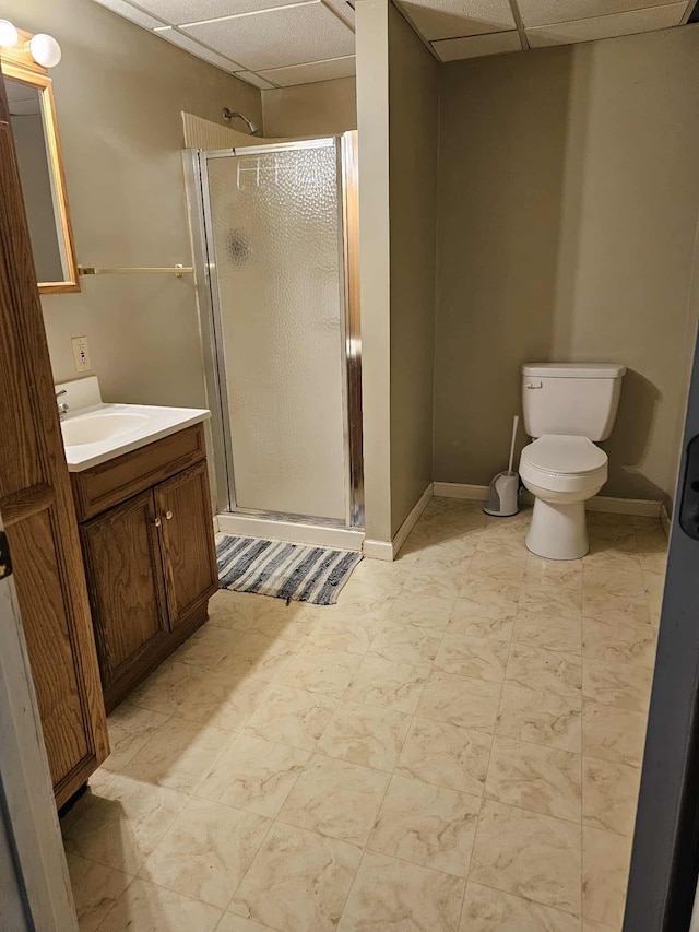 102 Hazelnut Ave, Camden, TN 38320 - full bathroom featuring a paneled ceiling, a stall shower, vanity, toilet, and baseboards