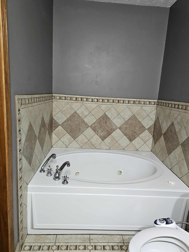 102 Hazelnut Ave, Camden, TN 38320 - bathroom with a jetted tub, tile patterned floors, and toilet
