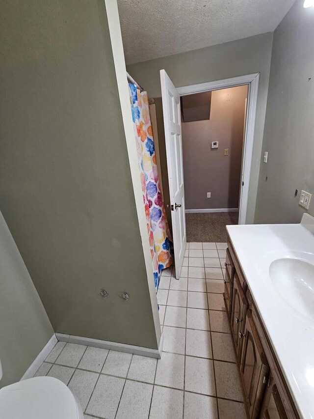 102 Hazelnut Ave, Camden, TN 38320 - full bath with vanity, a shower with shower curtain, tile patterned flooring, toilet, and baseboards