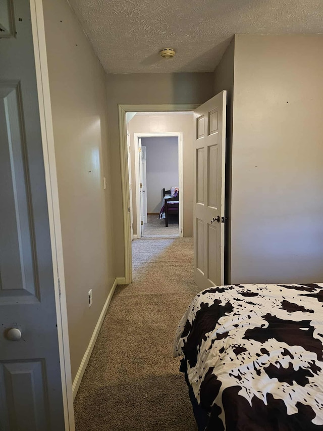 102 Hazelnut Ave, Camden, TN 38320 - bedroom with carpet, baseboards, and a textured ceiling
