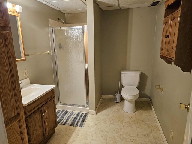 102 Hazelnut Ave, Camden, TN 38320 - bathroom with a stall shower, vanity, toilet, a drop ceiling, and baseboards