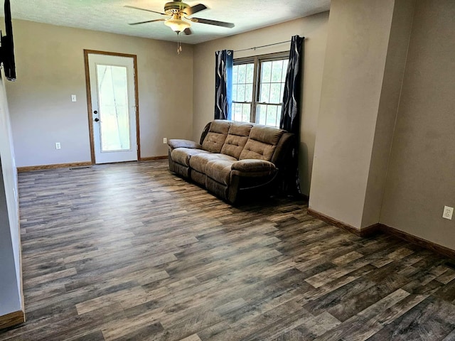102 Hazelnut Ave, Camden, TN 38320 - living area with dark wood finished floors, ceiling fan, and baseboards