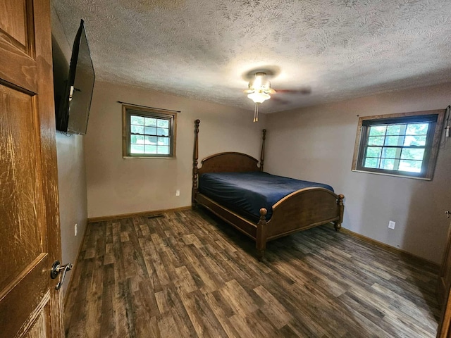 102 Hazelnut Ave, Camden, TN 38320 - bedroom with wood finished floors, a textured ceiling, and baseboards