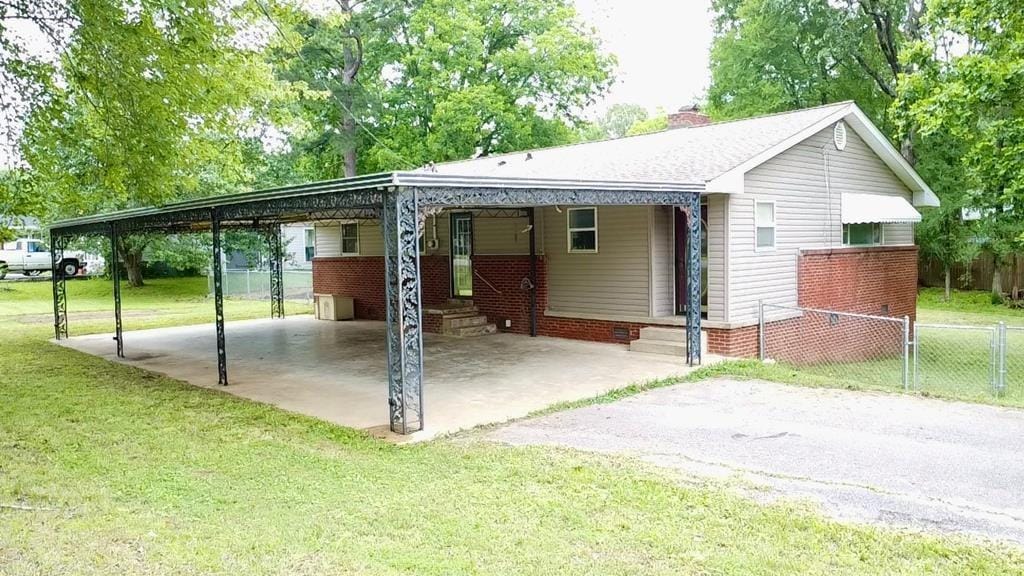 130 Highland Heights Ave, Camden, TN 38320 - view of front facade with a carport, driveway, a chimney, and entry steps