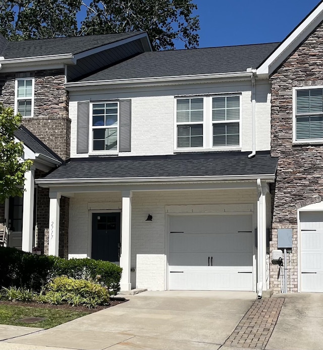 2717 Gossett Trl, Nashville, TN 37221 - view of front of property featuring an attached garage, driveway, stone siding, and a shingled roof