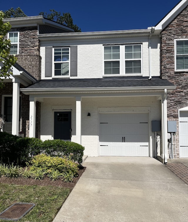 2717 Gossett Trl, Nashville, TN 37221 - view of front facade featuring concrete driveway, a garage, and brick siding