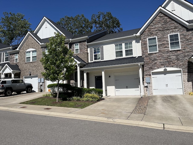 2717 Gossett Trl, Nashville, TN 37221 - view of front facade featuring board and batten siding, driveway, stone siding, and an attached garage