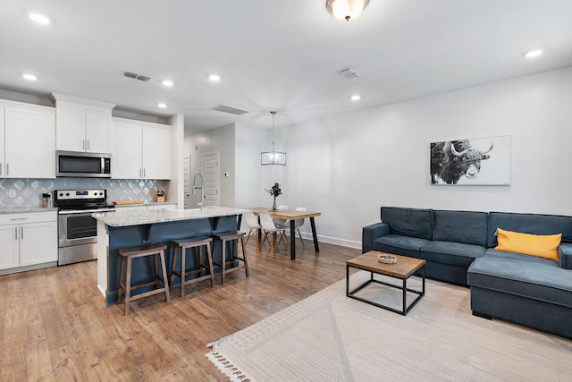 2717 Gossett Trl, Nashville, TN 37221 - living area featuring light wood-style floors, recessed lighting, and baseboards