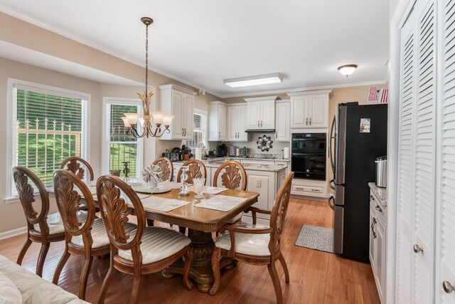 3871 Stevens Ln, Nashville, TN 37218 - dining area with a chandelier, light wood-type flooring, and ornamental molding