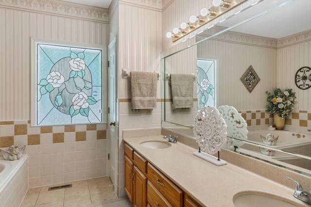 3871 Stevens Ln, Nashville, TN 37218 - bathroom featuring wallpapered walls, double vanity, a bath, tile walls, and tile patterned floors