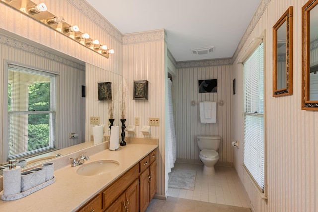 3871 Stevens Ln, Nashville, TN 37218 - full bath with wallpapered walls, vanity, toilet, and tile patterned floors