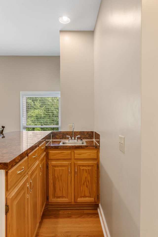 3871 Stevens Ln, Nashville, TN 37218 - kitchen featuring a sink, light wood finished floors, brown cabinets, and recessed lighting