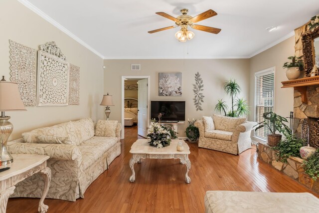 3871 Stevens Ln, Nashville, TN 37218 - living area featuring a ceiling fan, crown molding, wood finished floors, and a stone fireplace