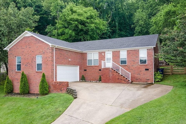 102 Mckinley Dr, Columbia, TN 38401 - ranch-style home featuring driveway, brick siding, roof with shingles, and a wooded view