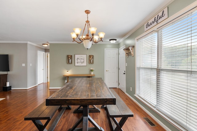 102 Mckinley Dr, Columbia, TN 38401 - dining area with a chandelier, wood finished floors, crown molding, and baseboards