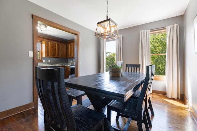 2890 Ellis Ln, Palmyra, TN 37142 - dining room featuring a chandelier, baseboards, and wood finished floors