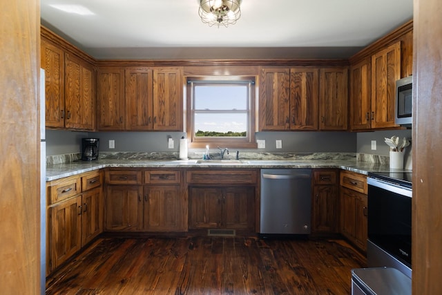 2890 Ellis Ln, Palmyra, TN 37142 - kitchen with stainless steel appliances, dark wood-style flooring, a sink, light stone countertops, and brown cabinetry