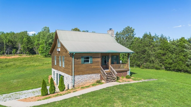 2890 Ellis Ln, Palmyra, TN 37142 - view of front of house featuring a porch, a chimney, a front yard, stairs, and stone siding