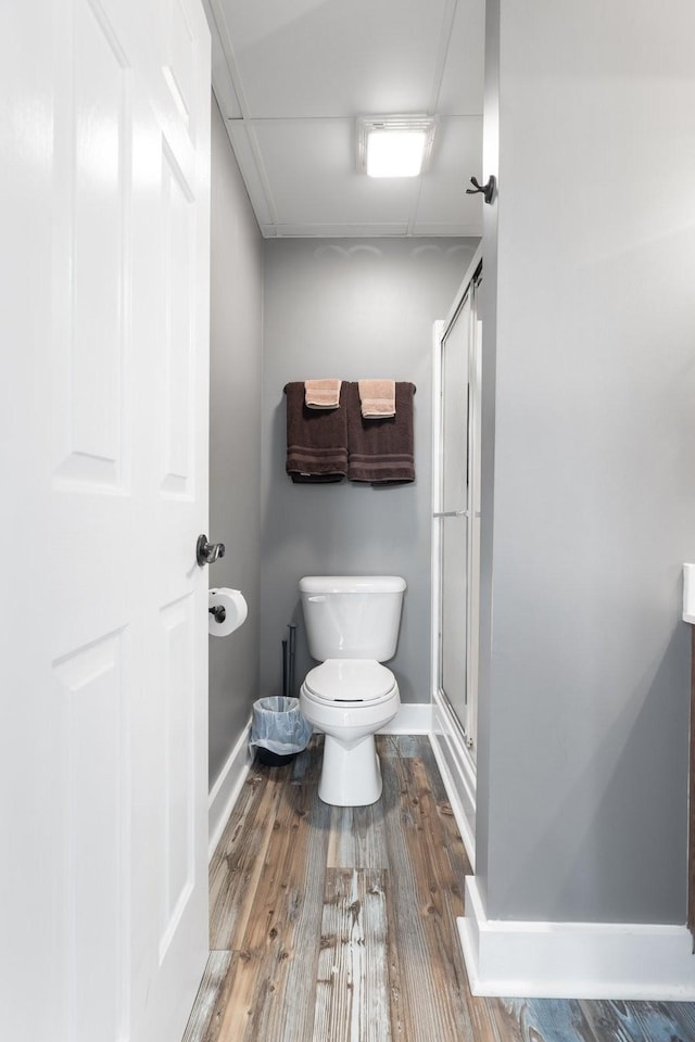 2890 Ellis Ln, Palmyra, TN 37142 - bathroom with toilet, a shower stall, wood finished floors, and baseboards