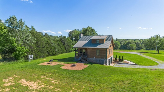 2890 Ellis Ln, Palmyra, TN 37142 - rear view of property with a yard, an attached garage, a chimney, and gravel driveway