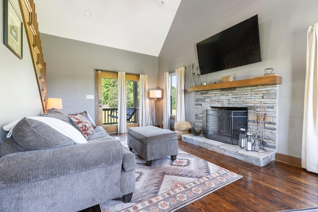 2890 Ellis Ln, Palmyra, TN 37142 - living room featuring wood finished floors, high vaulted ceiling, and a stone fireplace