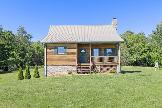 2890 Ellis Ln, Palmyra, TN 37142 - view of front of house featuring covered porch, a front lawn, a chimney, and metal roof