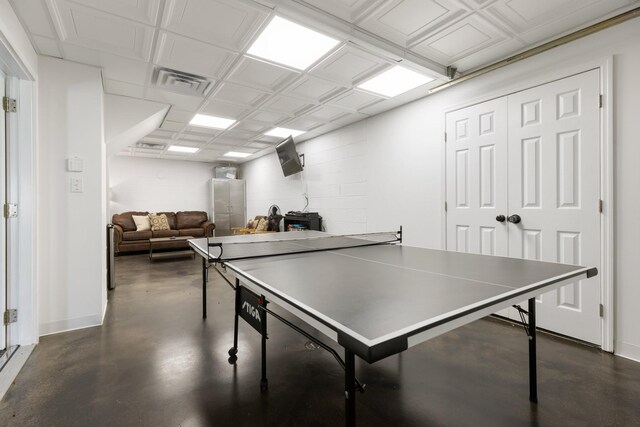 2890 Ellis Ln, Palmyra, TN 37142 - rec room with finished concrete flooring, a wood stove, and baseboards