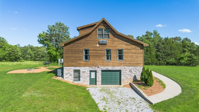 2890 Ellis Ln, Palmyra, TN 37142 - view of home's exterior featuring stone siding, a yard, gravel driveway, and a garage
