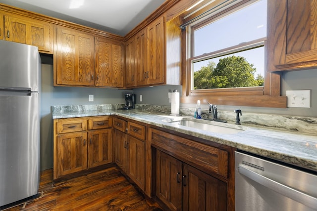 2890 Ellis Ln, Palmyra, TN 37142 - kitchen featuring appliances with stainless steel finishes, a sink, brown cabinets, dark wood-type flooring, and light stone countertops