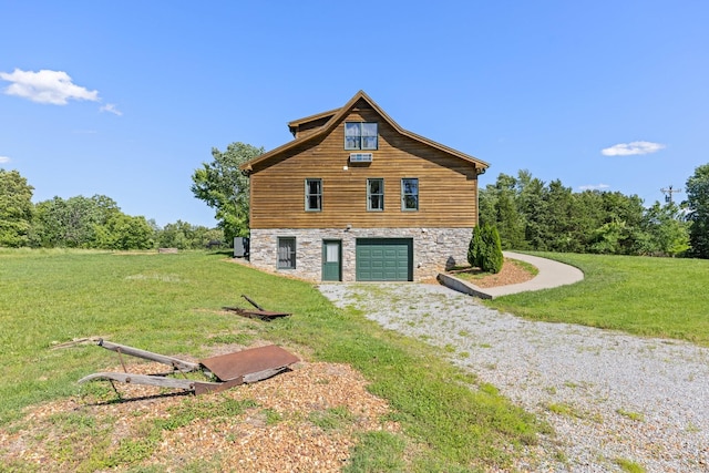 2890 Ellis Ln, Palmyra, TN 37142 - view of side of home featuring stone siding, driveway, a garage, and a lawn