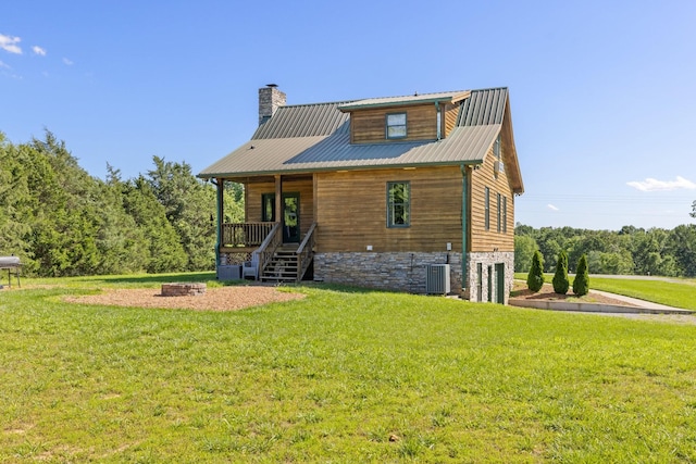 2890 Ellis Ln, Palmyra, TN 37142 - rear view of house with a lawn, central air condition unit, a chimney, covered porch, and a garage