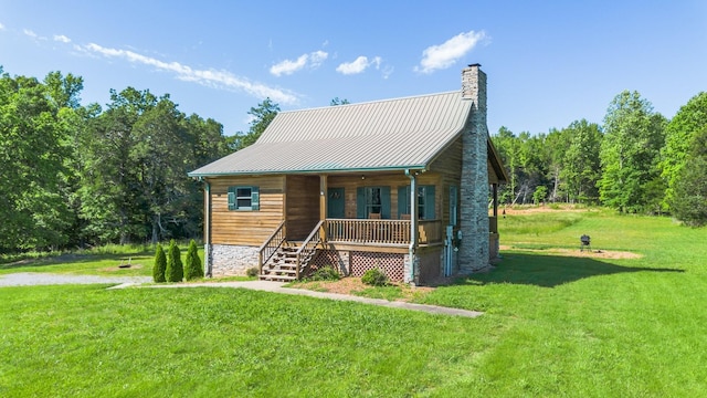 2890 Ellis Ln, Palmyra, TN 37142 - rustic home with covered porch, a front yard, a chimney, and metal roof