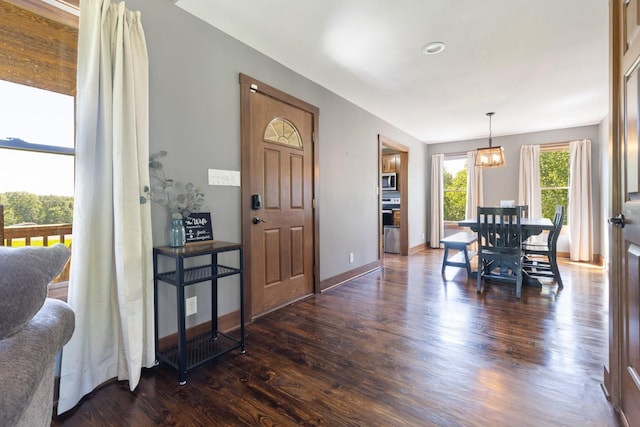 2890 Ellis Ln, Palmyra, TN 37142 - entrance foyer with dark wood-style floors, a chandelier, and baseboards