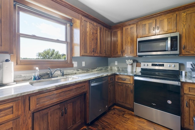 2890 Ellis Ln, Palmyra, TN 37142 - kitchen with appliances with stainless steel finishes, a sink, brown cabinets, and light stone counters