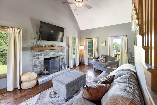 2890 Ellis Ln, Palmyra, TN 37142 - living area featuring a stone fireplace, ceiling fan, high vaulted ceiling, wood finished floors, and plenty of natural light