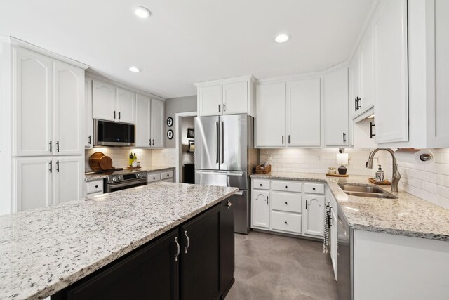 519 Glen Echo Dr, Old Hickory, TN 37138 - kitchen with appliances with stainless steel finishes, a sink, decorative backsplash, white cabinetry, and light stone counters
