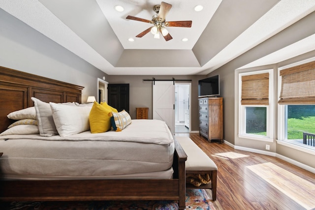 519 Glen Echo Dr, Old Hickory, TN 37138 - bedroom with a raised ceiling, baseboards, wood finished floors, a barn door, and recessed lighting
