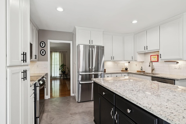 519 Glen Echo Dr, Old Hickory, TN 37138 - kitchen featuring appliances with stainless steel finishes, a sink, dark cabinetry, white cabinetry, and backsplash