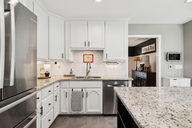 519 Glen Echo Dr, Old Hickory, TN 37138 - kitchen featuring appliances with stainless steel finishes, a sink, white cabinetry, tasteful backsplash, and light stone countertops