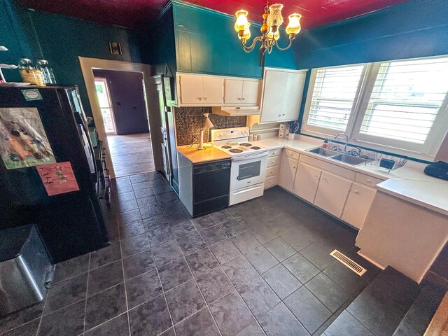 126 Carroll St S, Bruceton, TN 38317 - kitchen featuring electric range, a sink, under cabinet range hood, tasteful backsplash, and a chandelier
