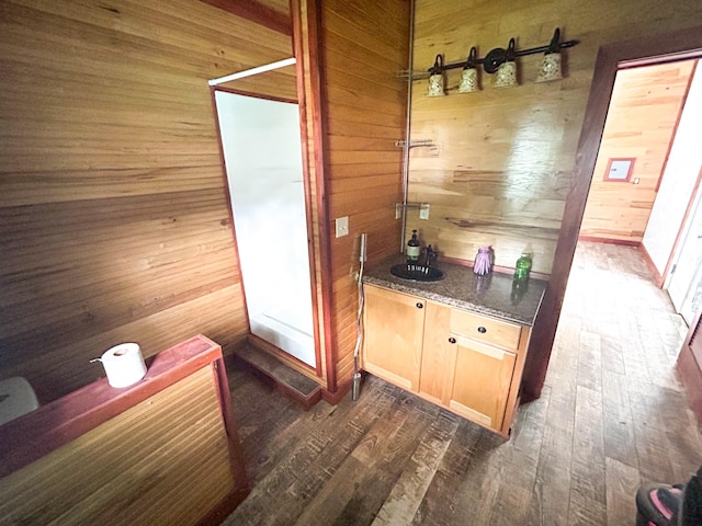 126 Carroll St S, Bruceton, TN 38317 - bathroom with wood walls, a sink, and wood finished floors