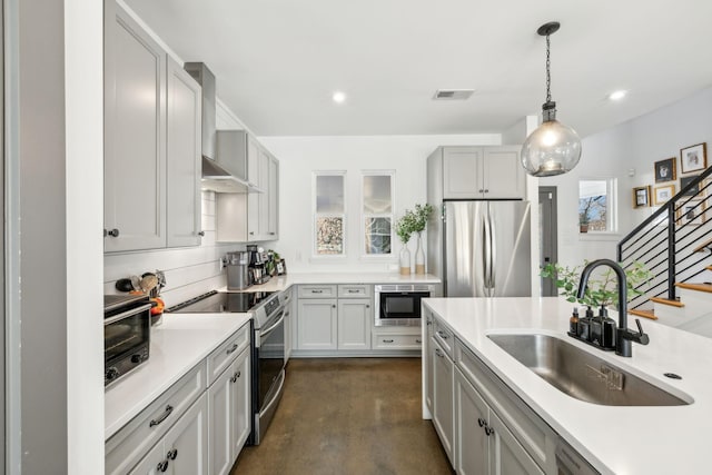 1609 Marsden Ave, Nashville, TN 37216 - kitchen featuring a sink, stainless steel appliances, wall chimney exhaust hood, light countertops, and pendant lighting