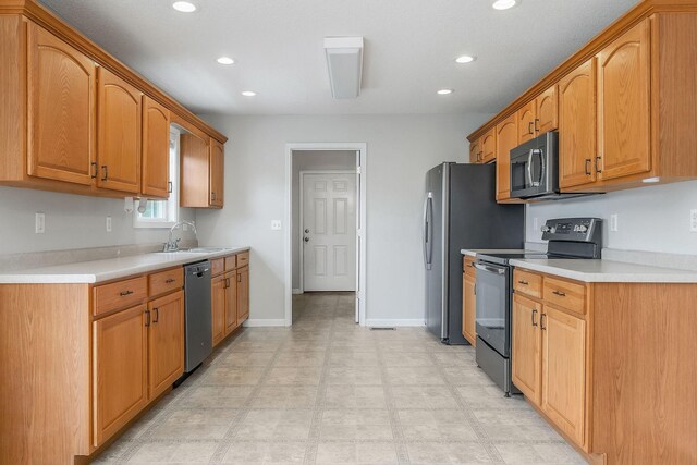 3408 Wj Robinson Rd, Cookeville, TN 38506 - kitchen featuring appliances with stainless steel finishes, a sink, recessed lighting, light countertops, and baseboards