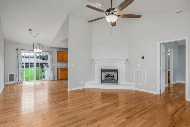 3408 Wj Robinson Rd, Cookeville, TN 38506 - unfurnished living room with high vaulted ceiling, ceiling fan, a fireplace, light wood-type flooring, and baseboards