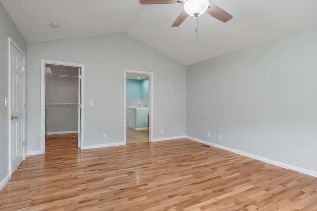3408 Wj Robinson Rd, Cookeville, TN 38506 - unfurnished bedroom featuring light wood finished floors, vaulted ceiling, a spacious closet, a closet, and baseboards
